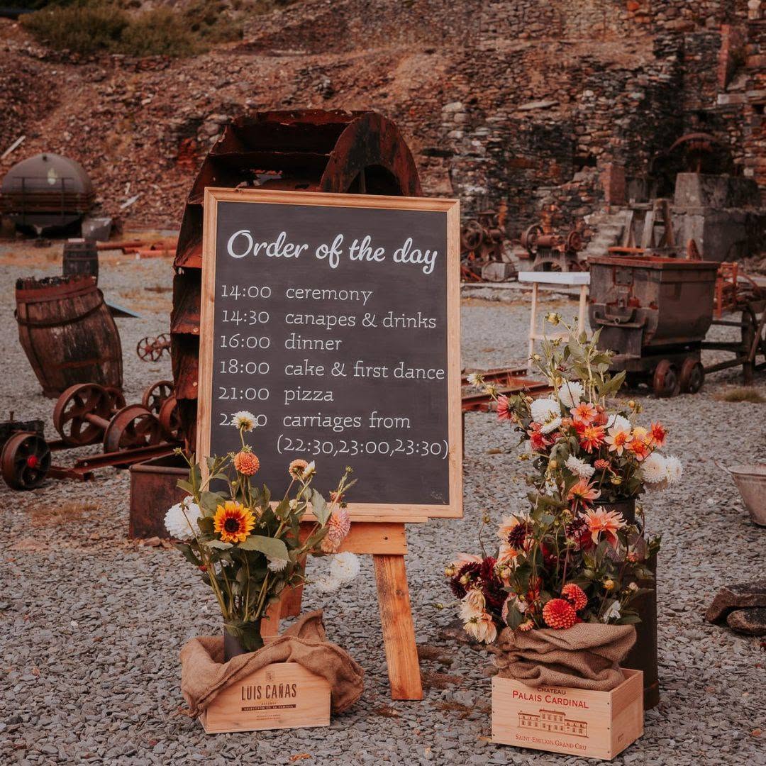 Handwritten order of the day chalkboard on a wooden easel with floral crates